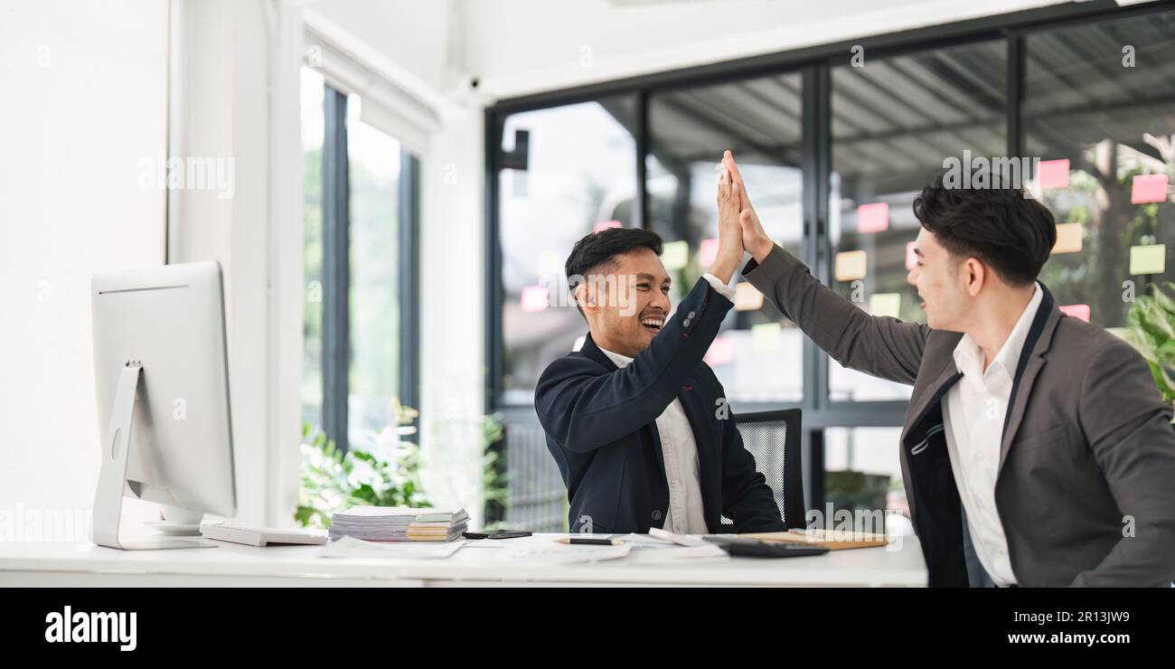 Business people celebrating success in an office. Business team giving ...