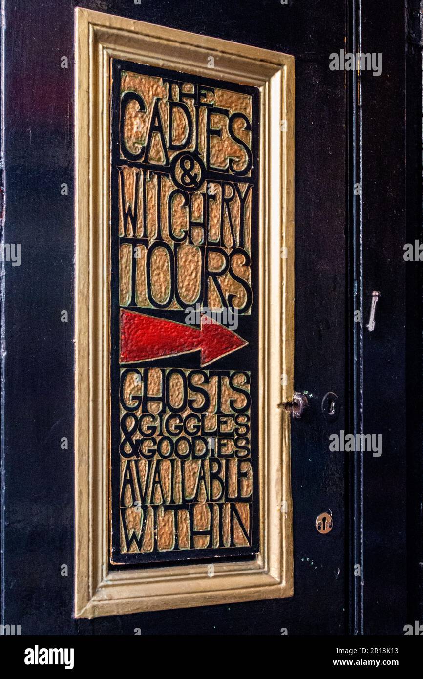 Gold gilt and red engraved sign on the outside of The Cadies and Witchery Tours shop on Victoria Street, Old Town, Edinburgh. Stock Photo