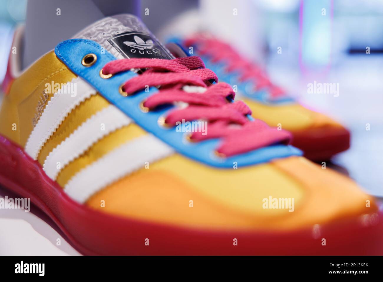 11 May 2023, Bavaria, Fürth: The logo of sporting goods manufacturer adidas  AG and the lettering of fashion company Gucci can be seen on the sidelines  of the adidas Annual General Meeting
