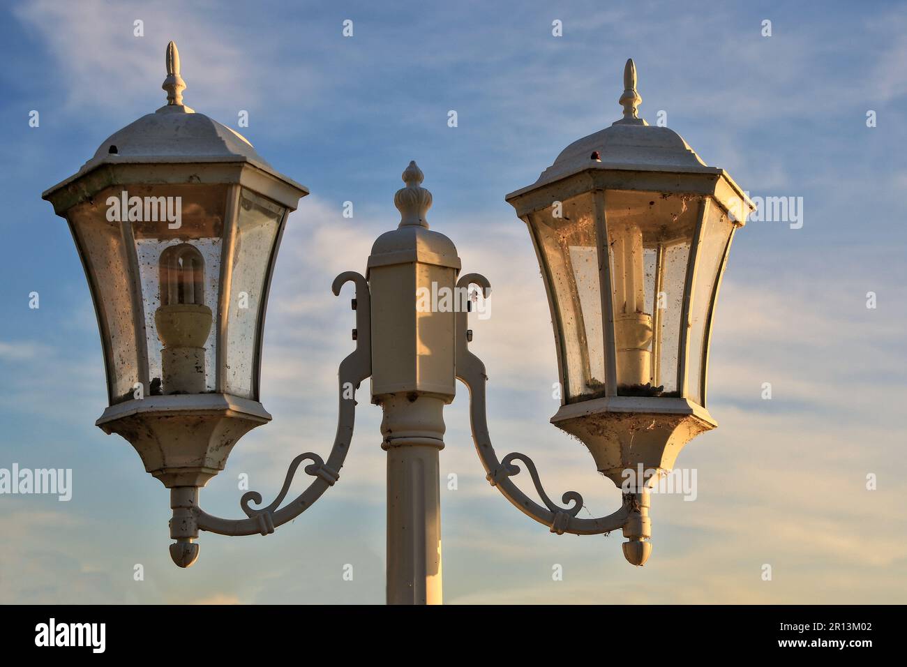 white double lamp In a park where the evening sunlight shines through Stock Photo