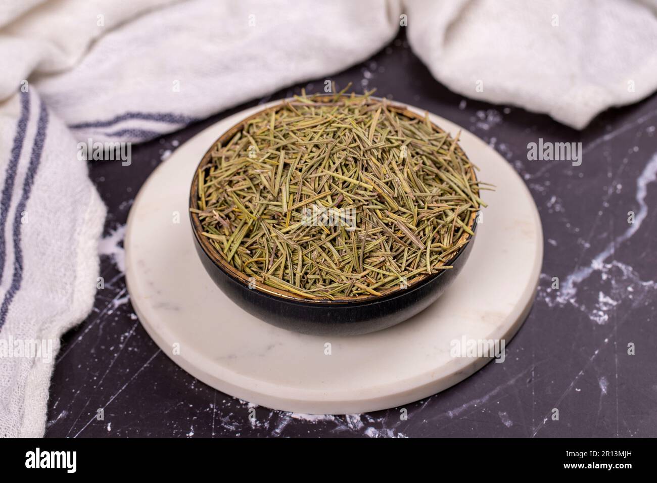 Dried herbs rosemary leaf. Dry seasoning rosemary on dark background. Spices and herbs for cooking, provence herbs Stock Photo