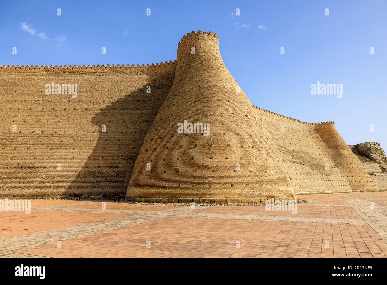 wide angle view of the massive walls and towers of the citadel of the ark of bukhara uzbekistan Stock Photo