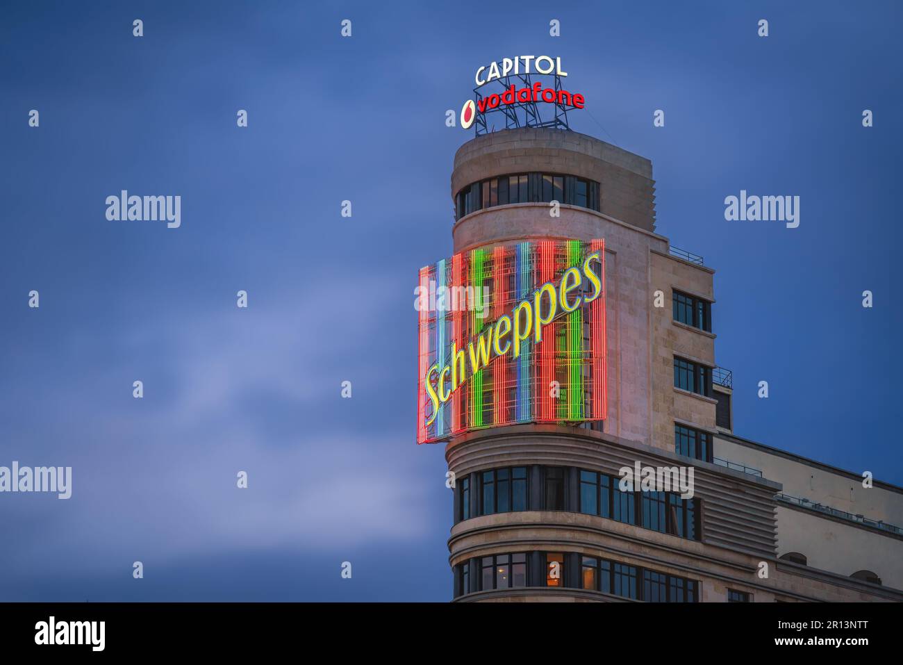 Schweppes neon sign of Edificio Capitol (or Carrion) Building at Gran Via Street - Madrid, Spain Stock Photo