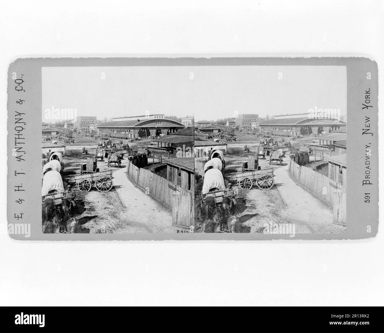 View of railroad depot and surroundings, Atlanta, Ga.. Railroad depot in background, covered wagons in foreground.1 photographic print on stereo card : stereograph. Created November 1864, Barnard, George N., 1819-1902, photographer. Stock Photo