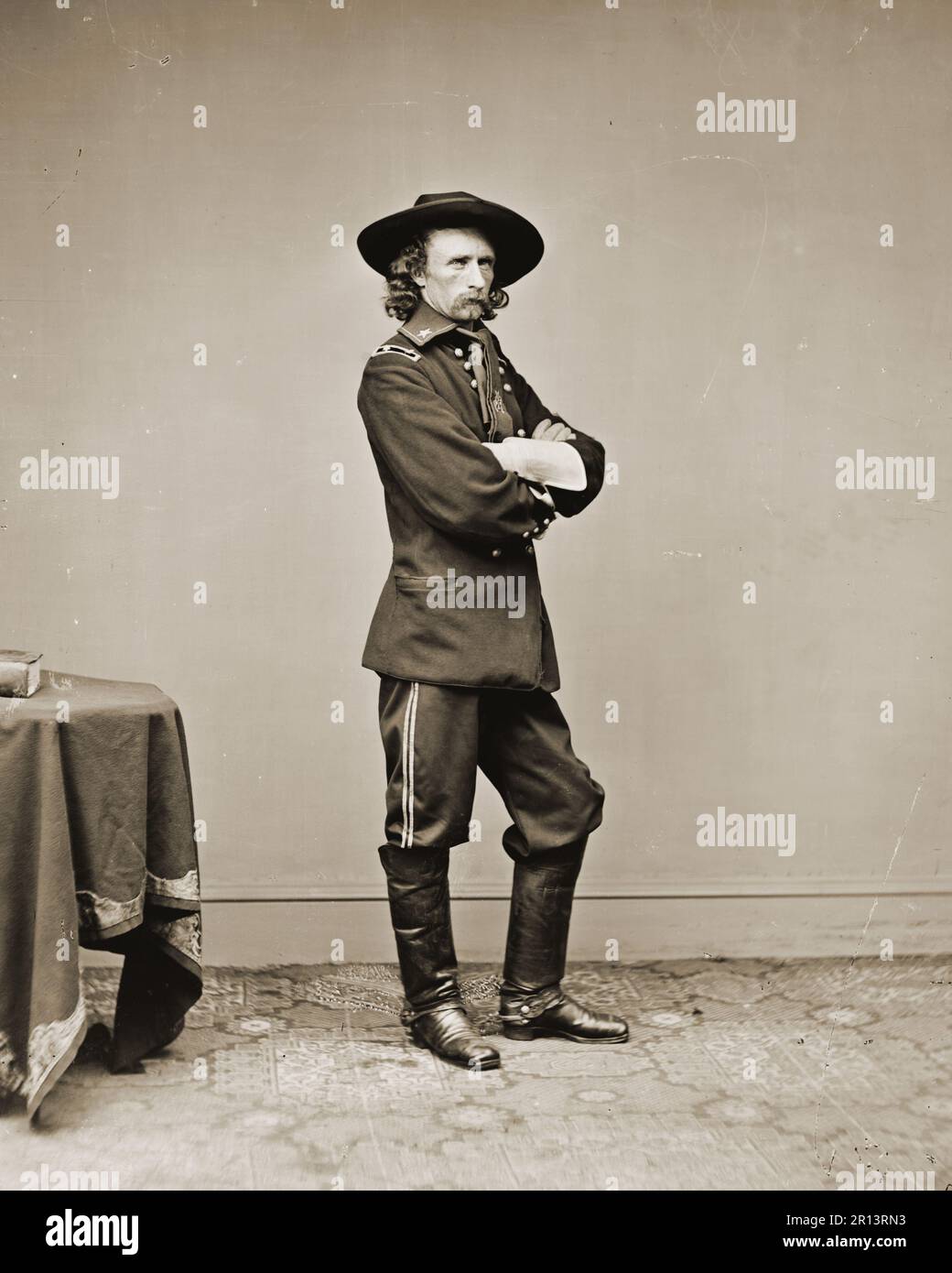General George Custer, U.S. Army -Full length standing.Annotation from negative, scratched on emulsion: Genl. Custer, 510, 13239; in pencil: Gen. Custer. Photographed between 1860 and 1865. Stock Photo