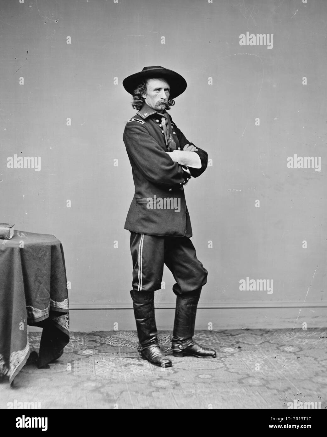 General George Custer, U.S. Army -Full length standing.Annotation from negative, scratched on emulsion: Genl. Custer, 510, 13239; in pencil: Gen. Custer. Photographed between 1860 and 1865. Stock Photo
