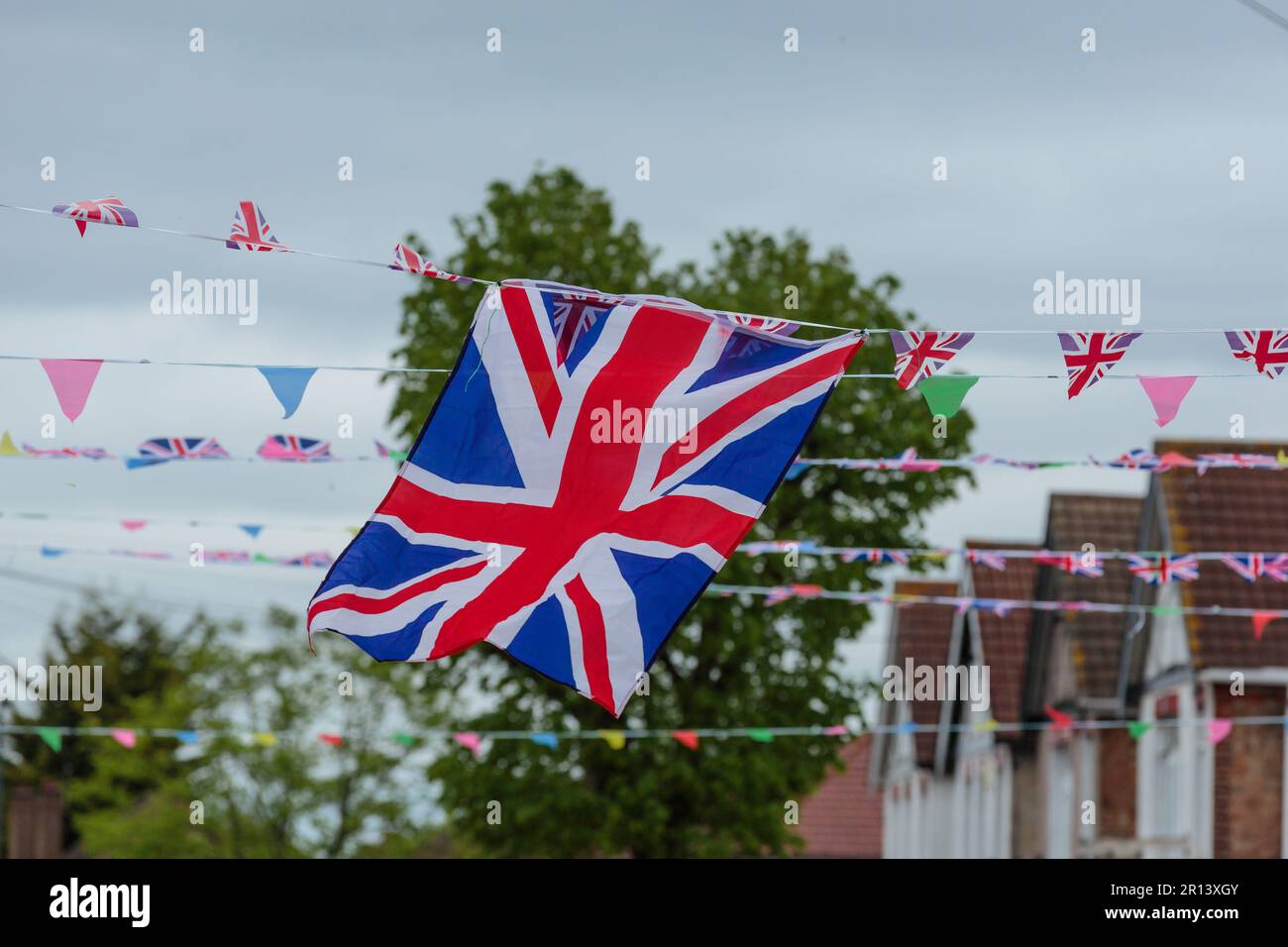 Wembley, Middx, UK. Coronation Street Party. A residential road in Wembley UK decorated with colourful Union Jack bunting and flags in preparation for Stock Photo