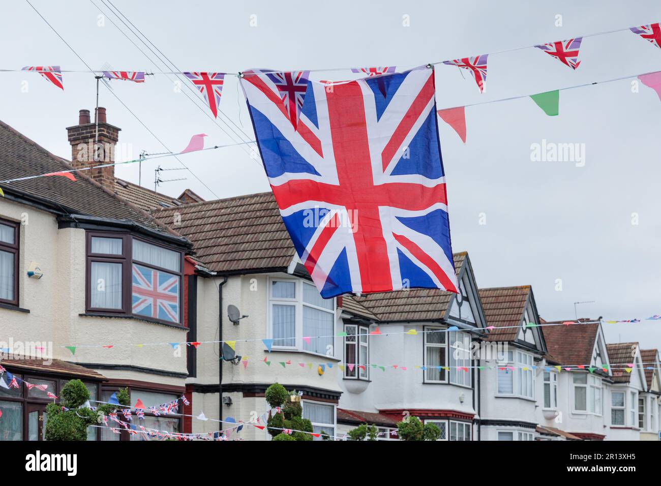 Wembley, Middx, UK. Coronation Street Party. A residential road in Wembley UK decorated with colourful Union Jack bunting and flags in preparation for Stock Photo