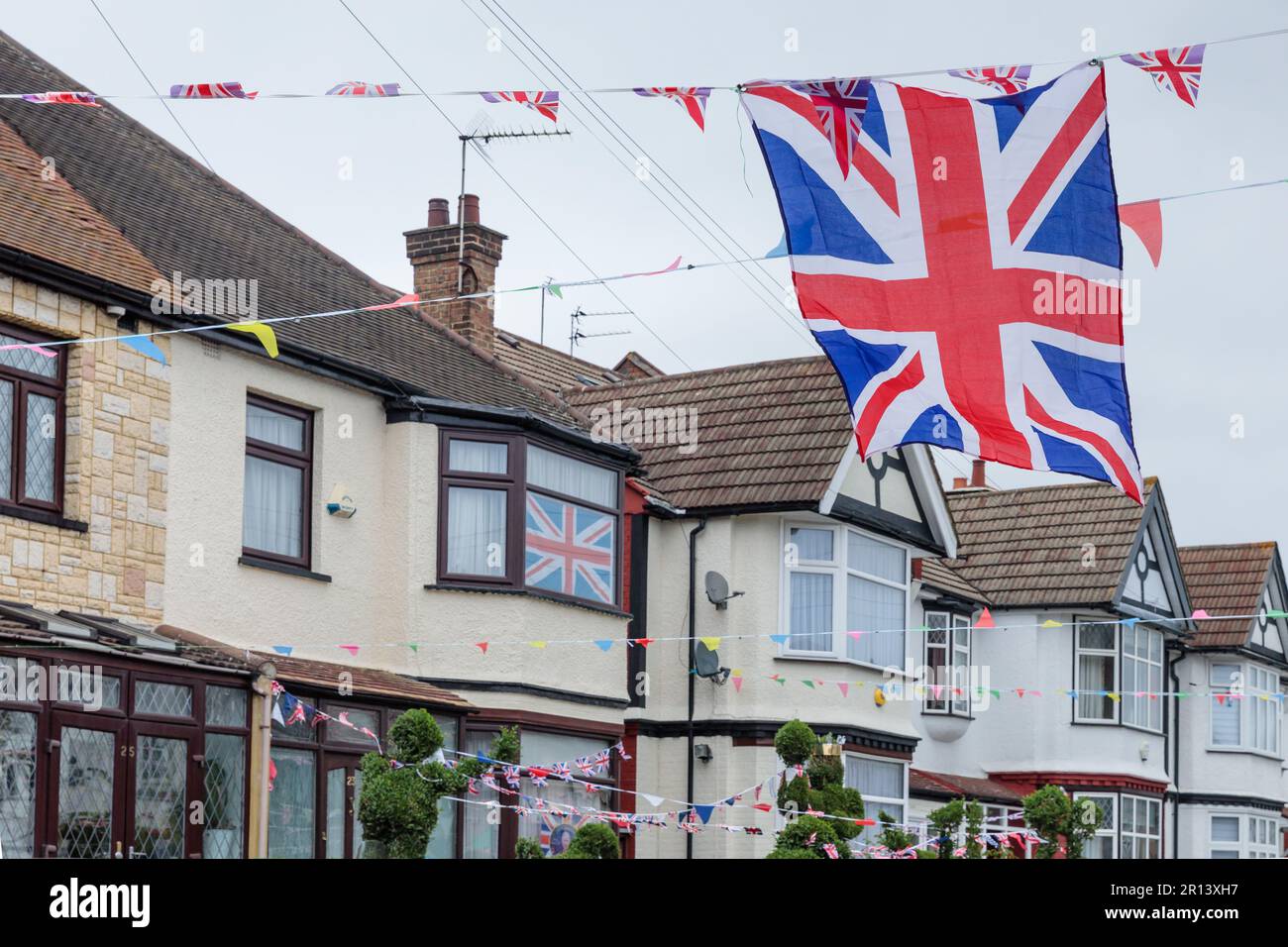 Wembley, Middx, UK. Coronation Street Party. A residential road in Wembley UK decorated with colourful Union Jack bunting and flags in preparation for Stock Photo