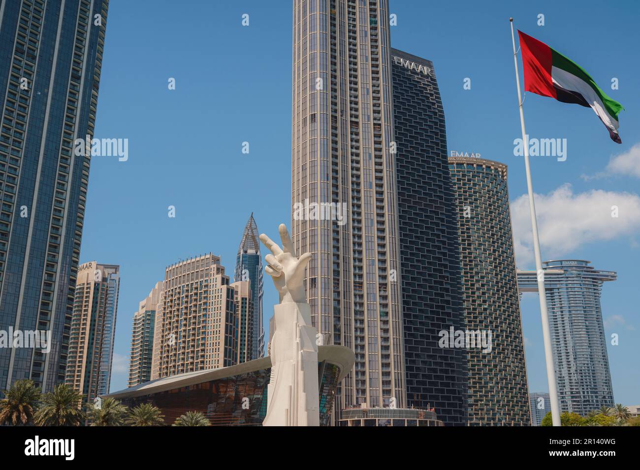 20 March 2023, Dubai, UAE three fingers statue near UAE flag in sunny
