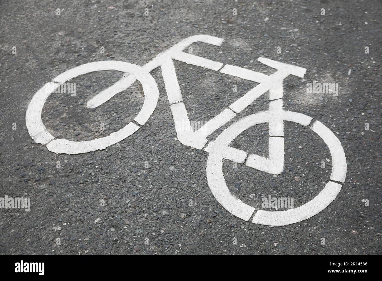 Bicycle lane with white sign painted on asphalt Stock Photo - Alamy