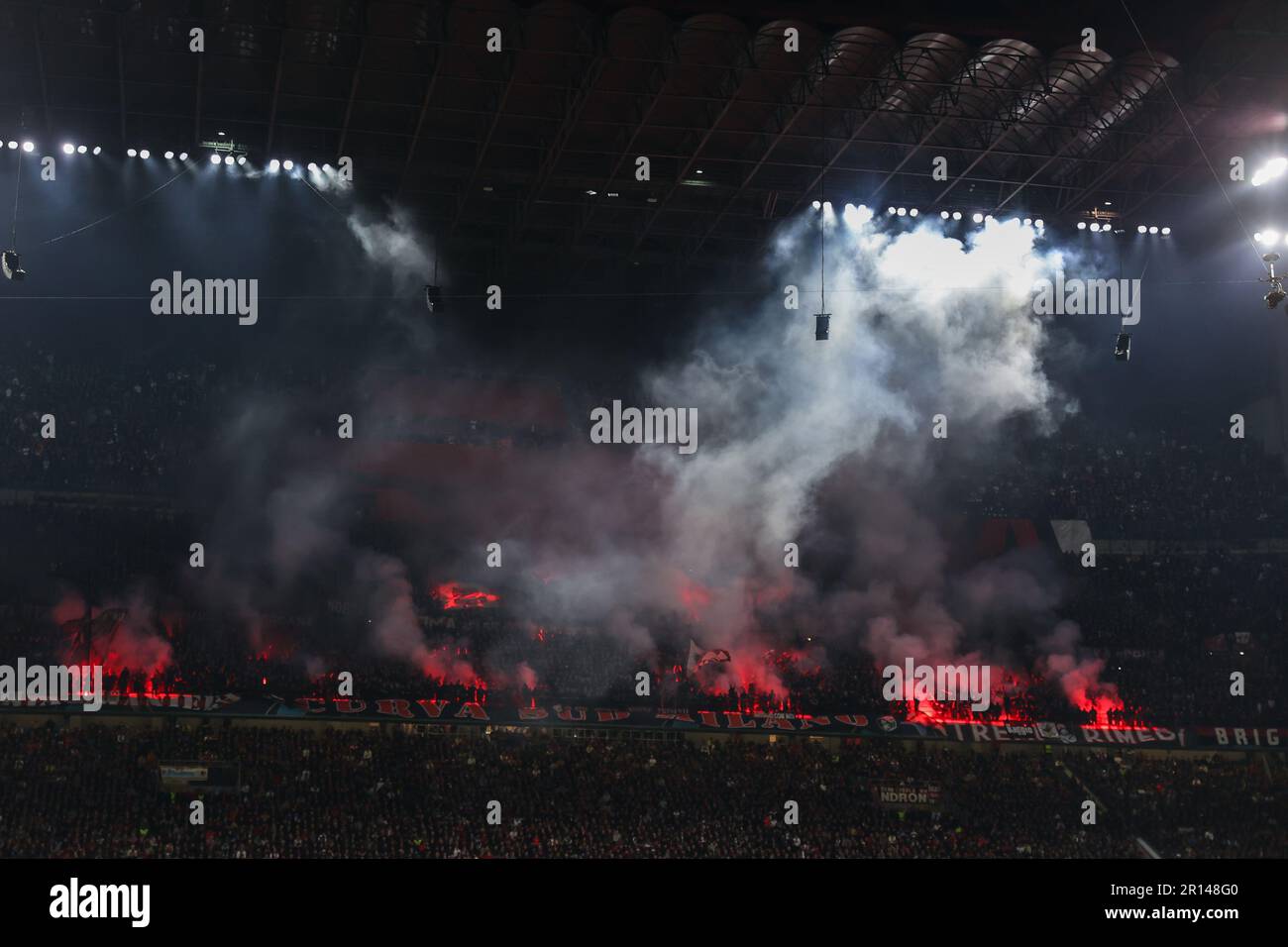 AC Milan supporters use smoke flares during UEFA Champions League 2022/23 Semi-Final 1st  leg football match between AC Milan and FC Internazionale at Stock Photo