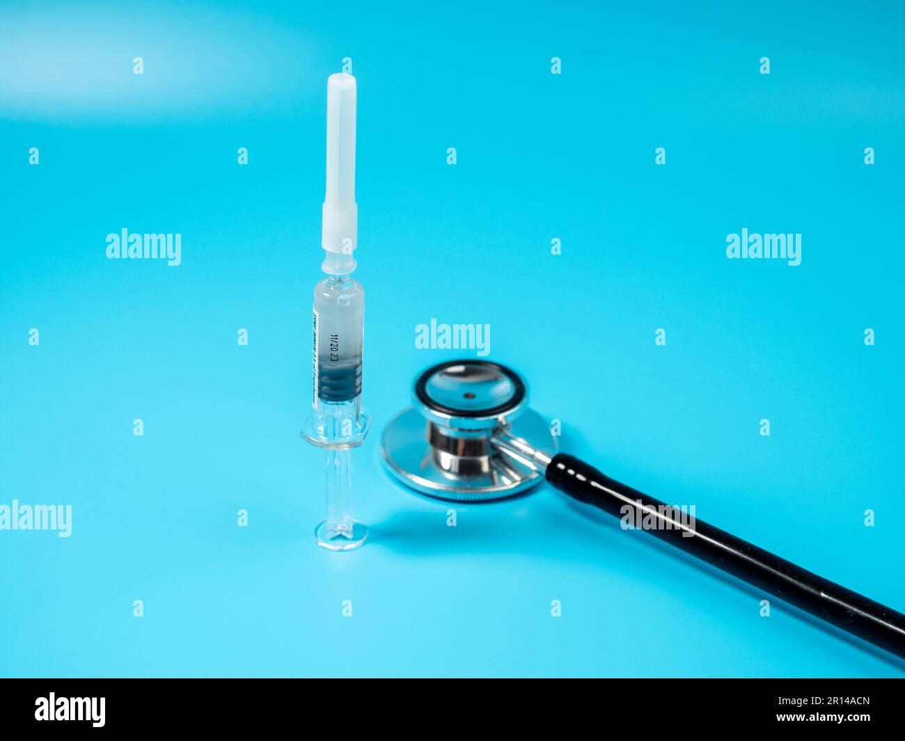 Injection vaccine on a blue background, medicine concept. On the