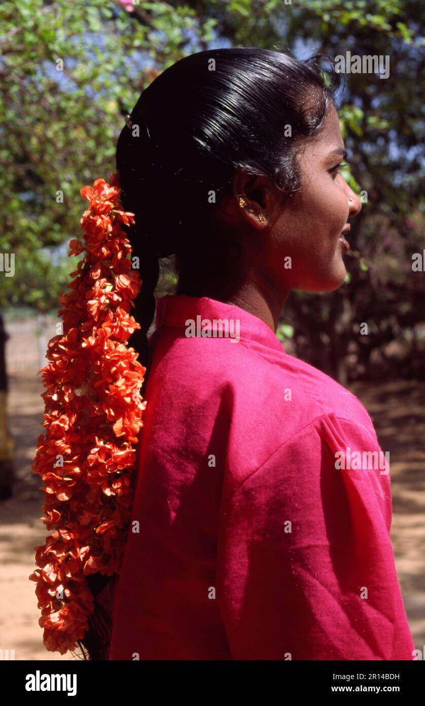Girl with flowers in her hair traditionally wear fresh flowers in their hair every day.Tamil Nadu, India Stock Photo