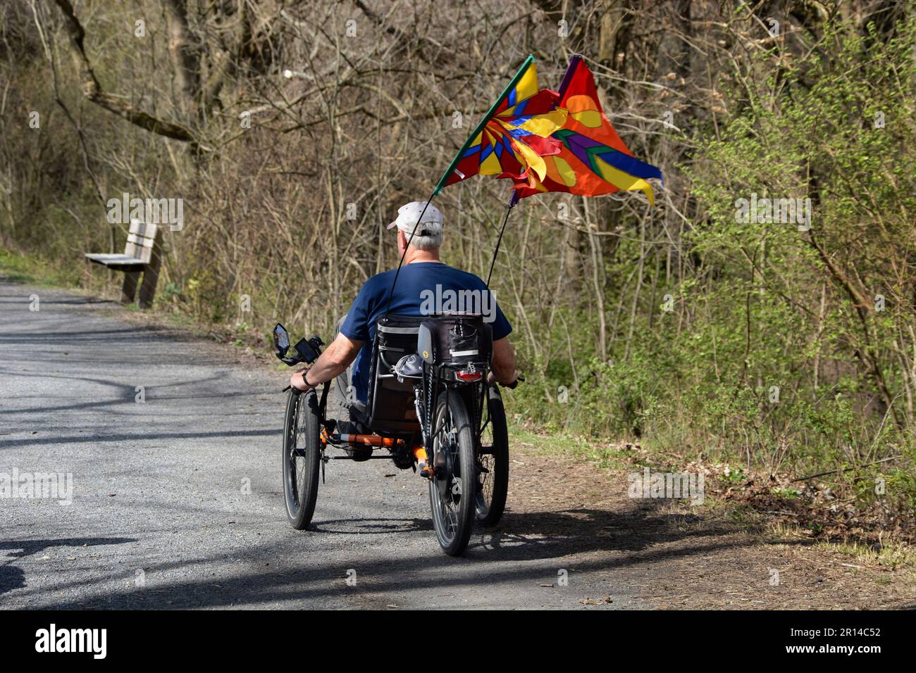 A man riding a recumbent trike bicycle rides along the Virginia Creeper