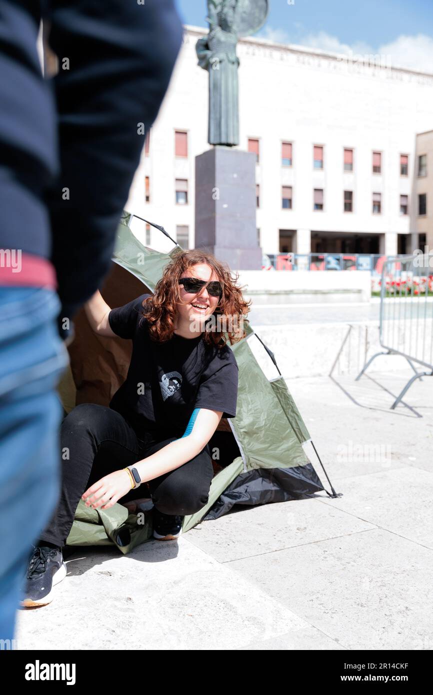 Unity in Protest: Students of Sapienza University in Rome share a moment of camaraderie in their encampment during a protest against rising rental. Stock Photo