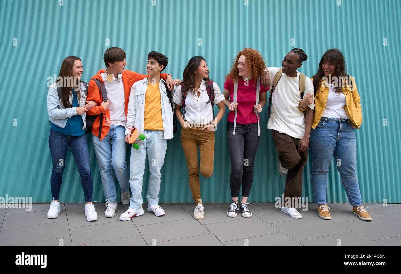 Multiracial group of cheerful erasmus students enjoying free time. Generation z youth relationships. Stock Photo