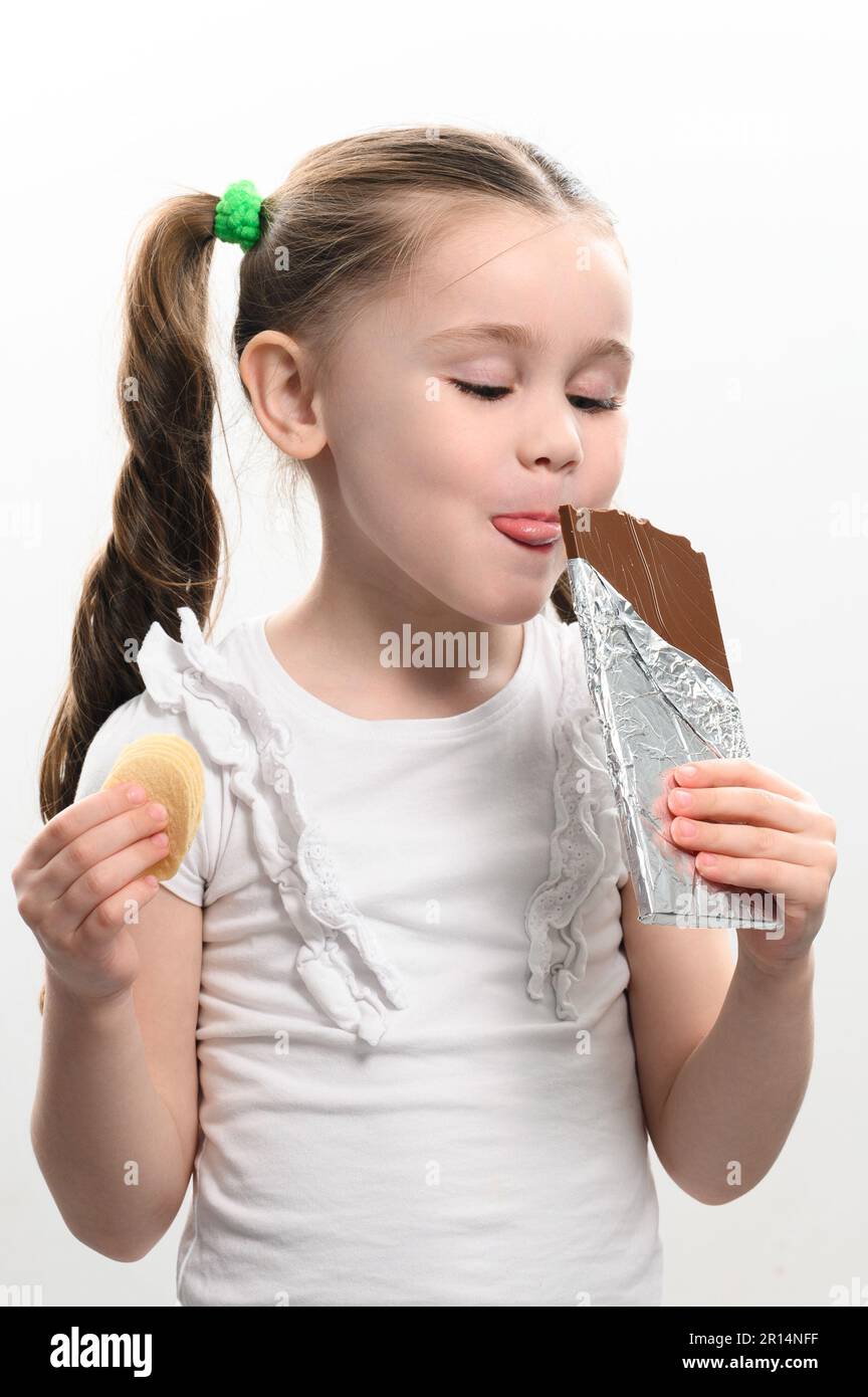 The child eats unhealthy and unhealthy food, the girl has chocolate and