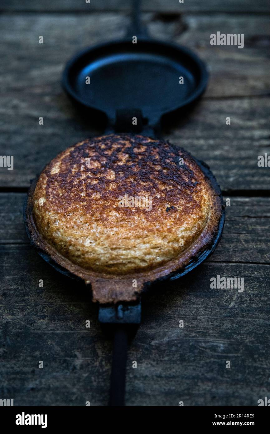 close up angled view or mountain, pudgie, campfire, hobo, camper pie, in a cast iron pie iron; mountain pies are a great camping dinner, which are coo Stock Photo