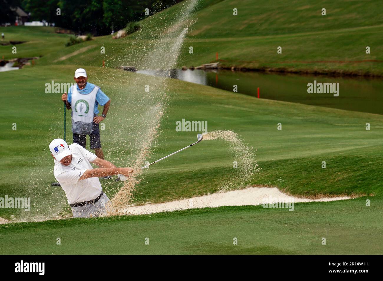 Billy Andrade attempts to hit out of the bunker on the 18th hole during