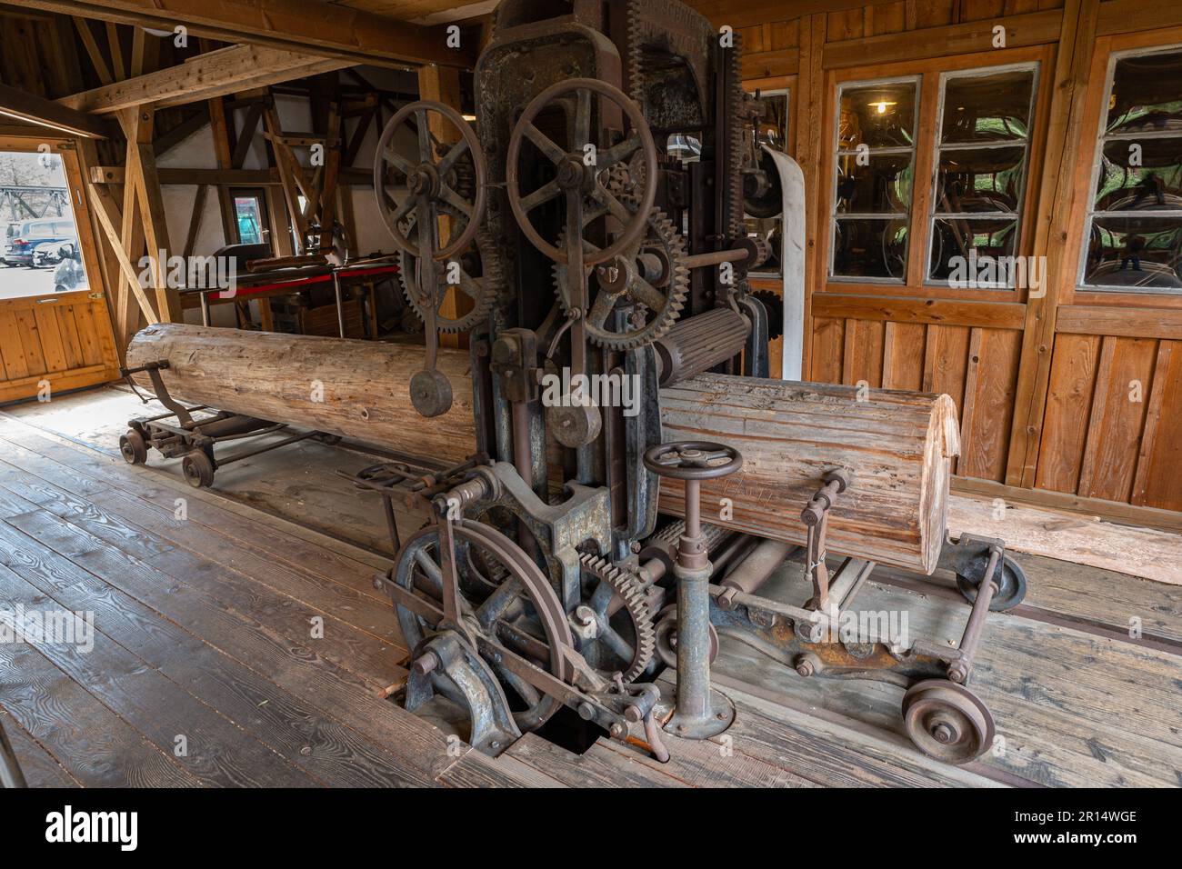 Tree trunk in the interior of an old hate sawmill. The construction is powered outside by water which sets the paddles of a water wheel in motion. Stock Photo