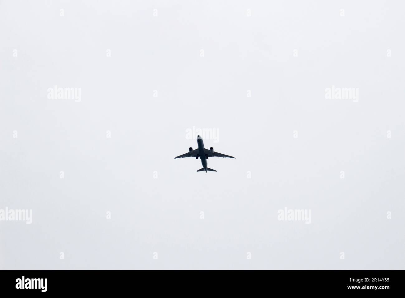 Passenger plane taking off in the dark cloudy sky Stock Photo