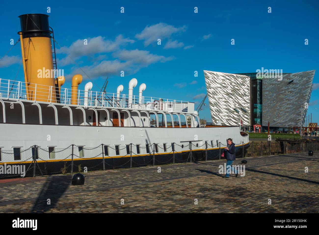 SS Nomadic in historic Hamilton Dock, with Titanic Belfast Exhibition building in background, in