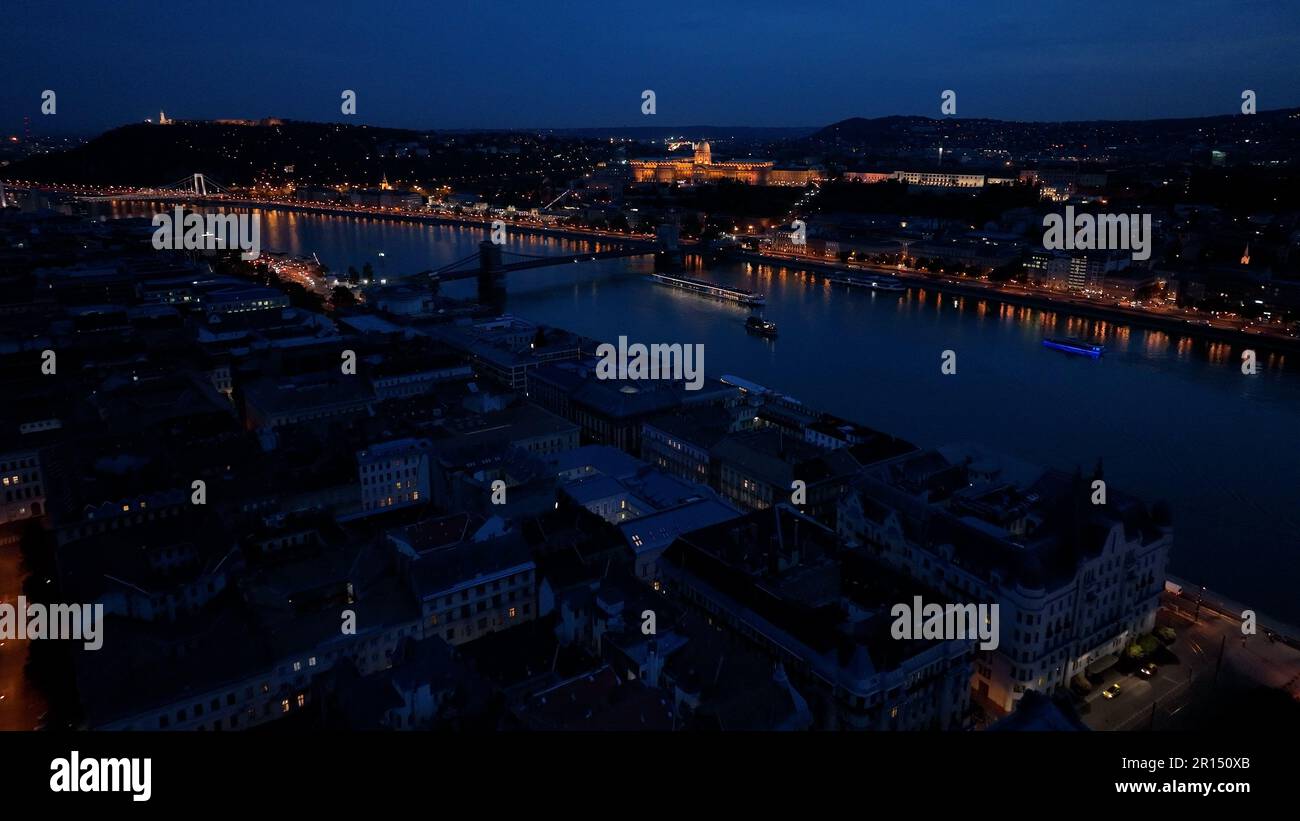 Aerial view of Castle Hill, Buda Castle, Gellert Hill and the Citadella with the Danube river, bridges illuminated after sunset in Budapest Stock Photo