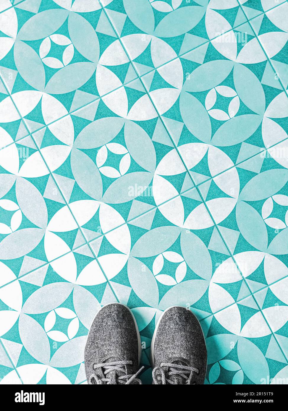 Top view of fabric shoes on a mosaic tile floor with copy space Stock Photo