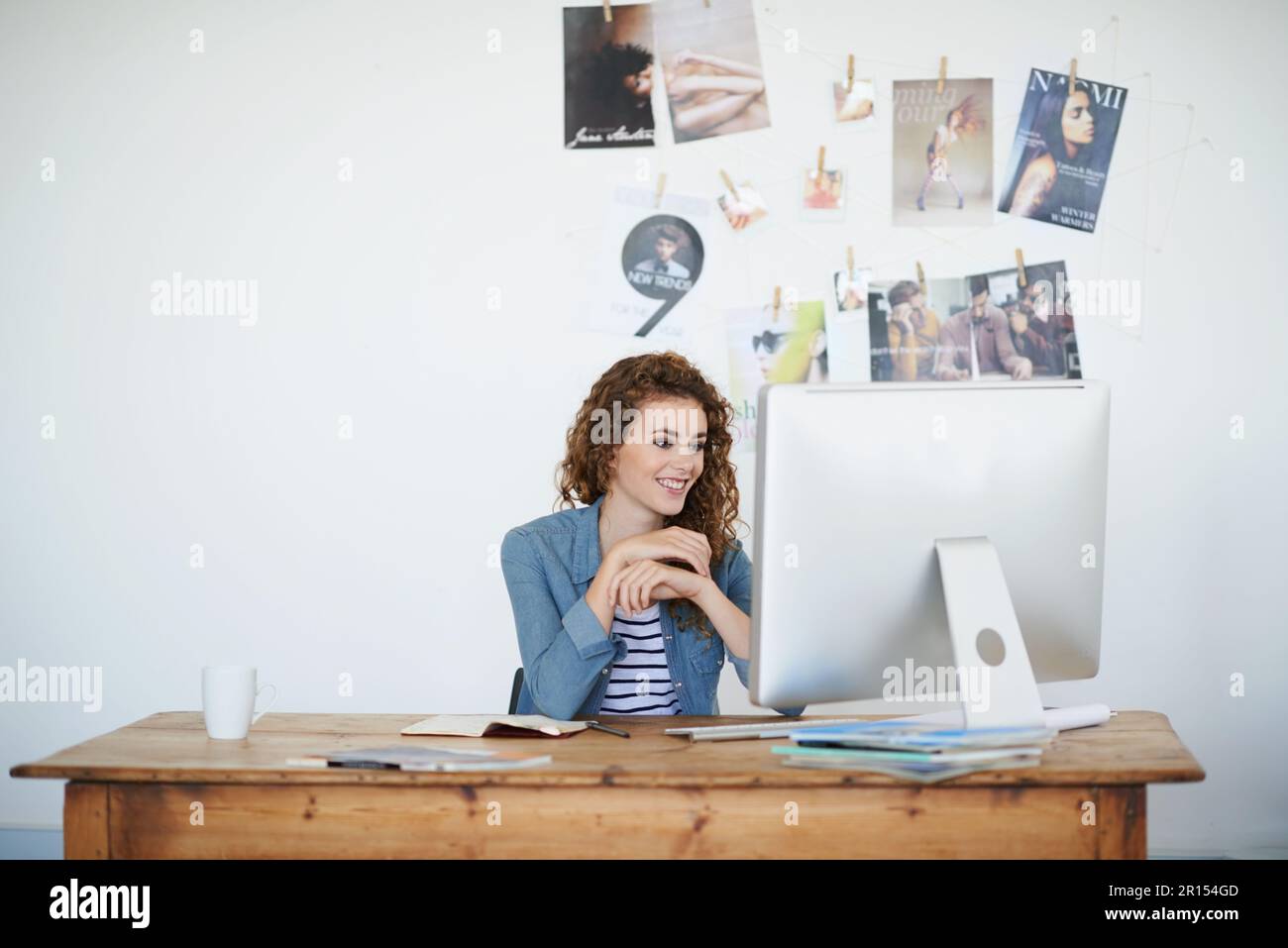 Working Perfectly The design looks perfect. a young woman working at her computer in an ...
