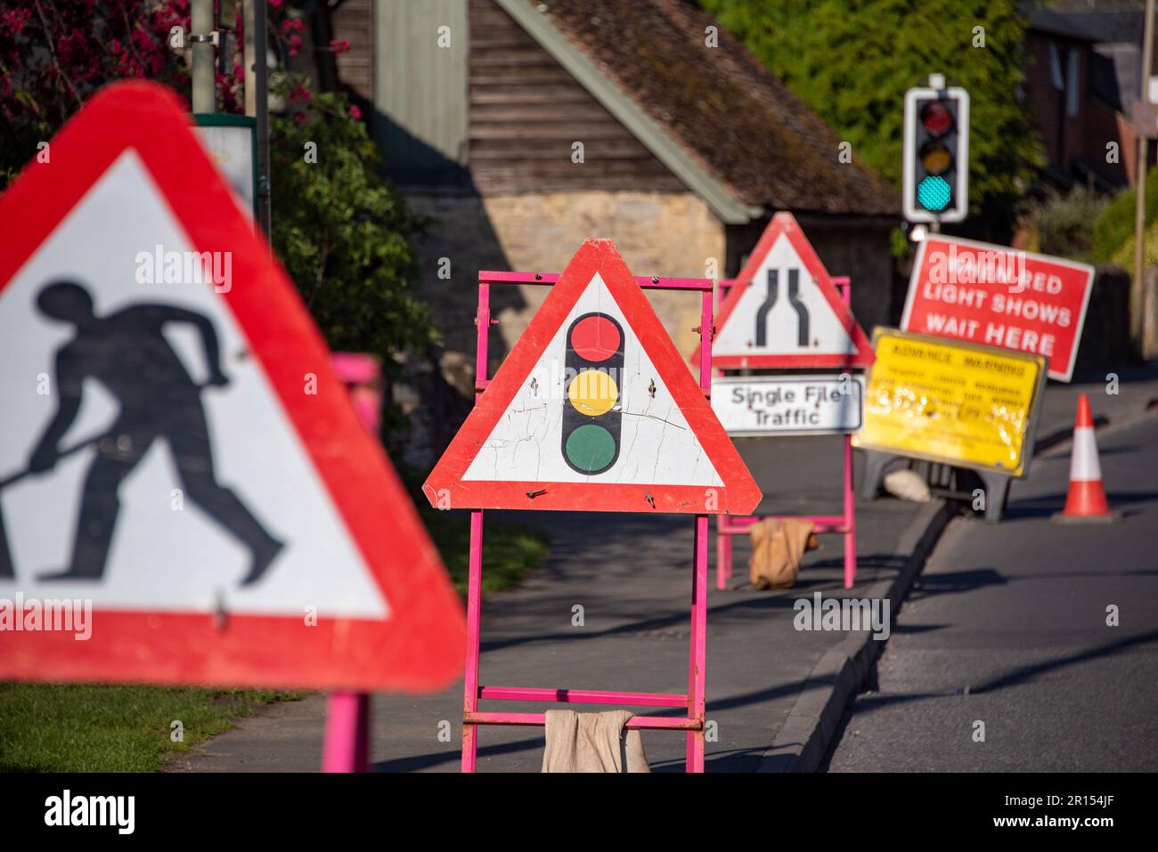 Roadworks signs and temporary traffic lights Stock Photo Alamy