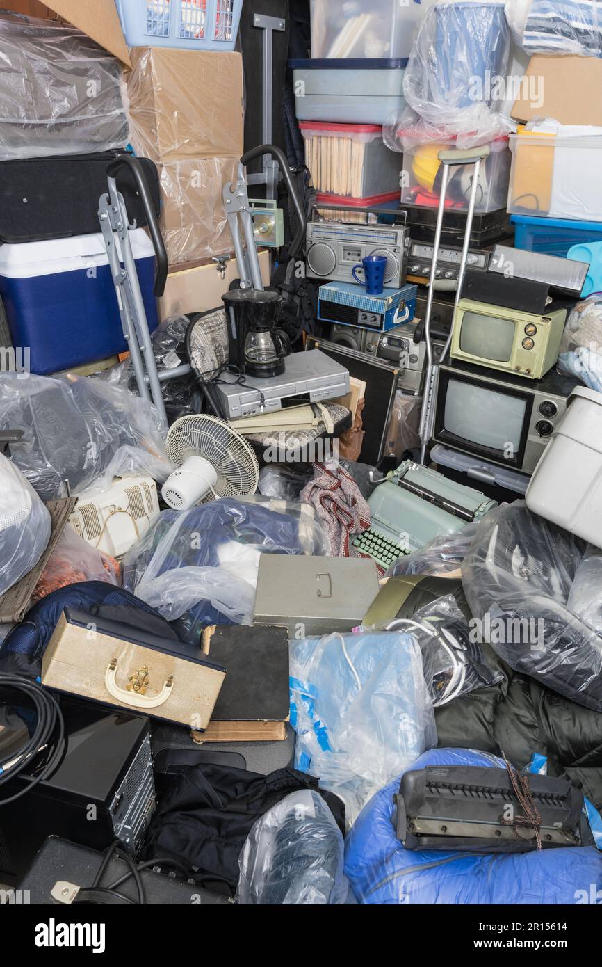 Hoarder house packed with clothing bags, household objects, vintage electronics and piles of junk. Stock Photo