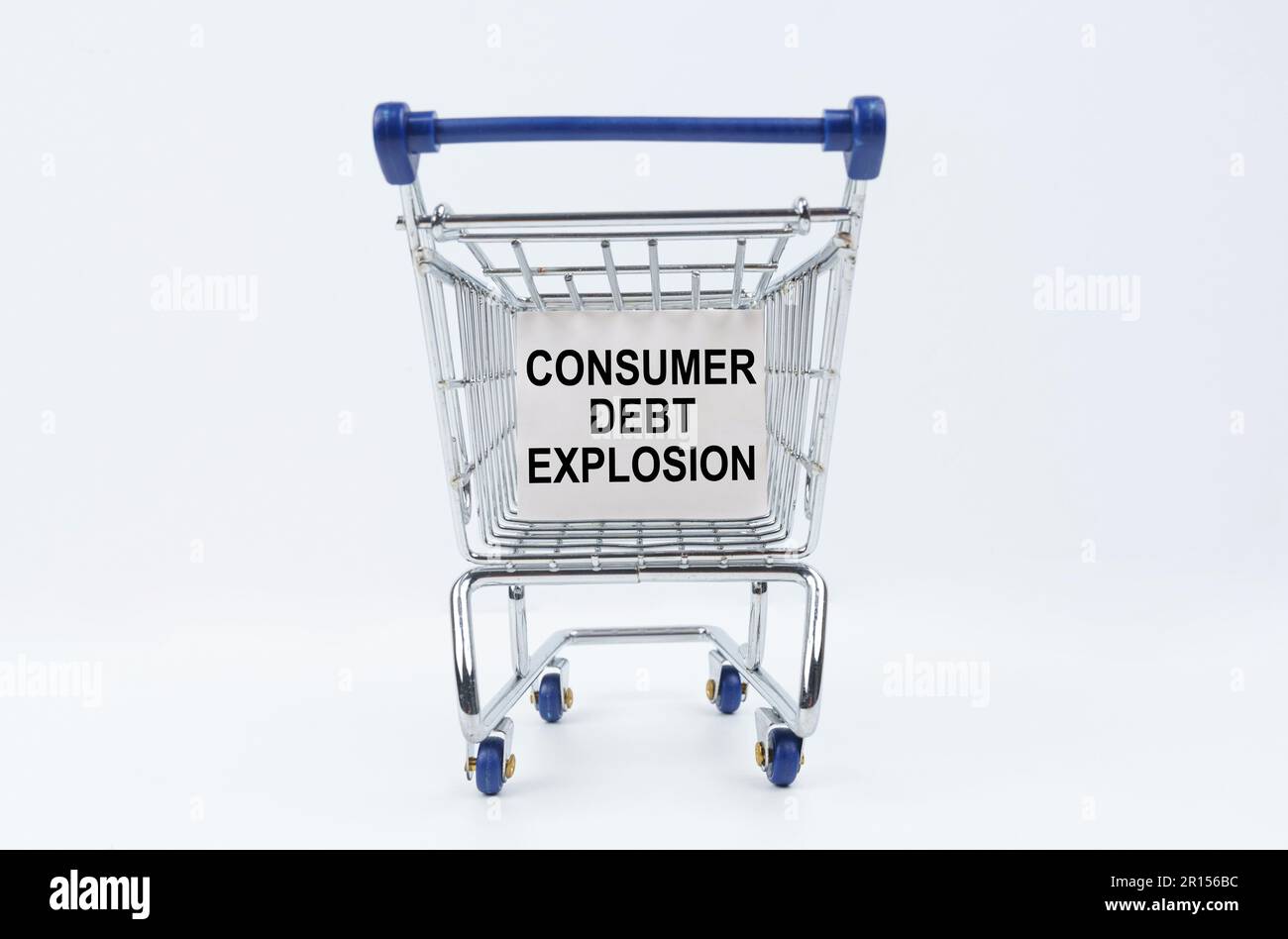 Business concept. On a white background is a shopping cart with a sign that says - Consumer debt explosion Stock Photo