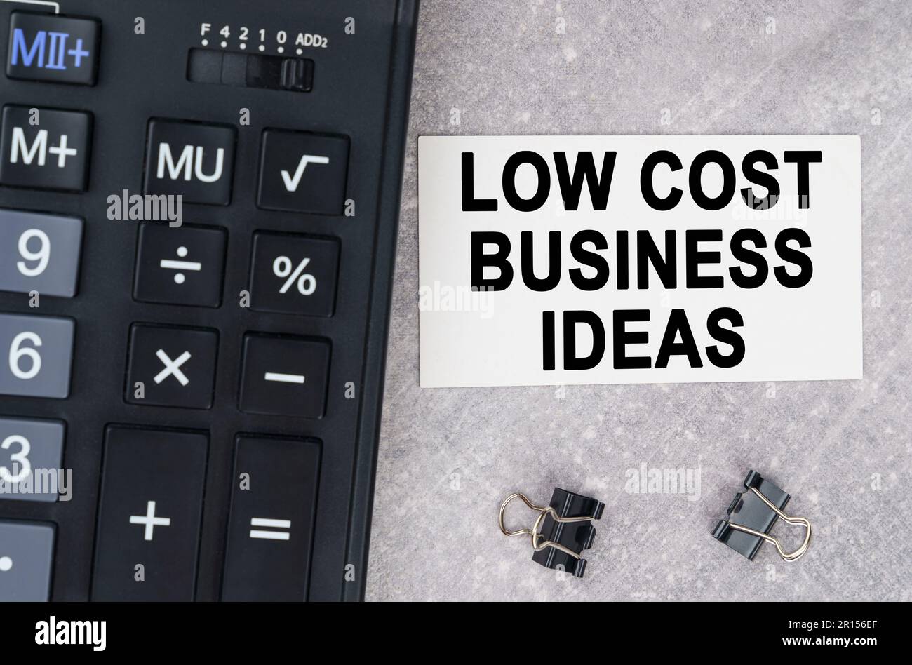 Business concept. On a gray surface lies a calculator, a pen and a