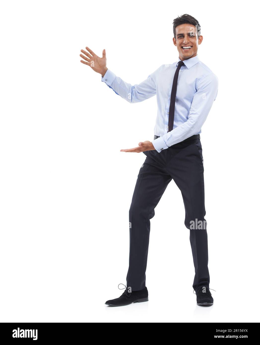 Take advantage of this copyspace. Portrait of a handsome young businessman gesturing towards the copy space and smiling. Stock Photo