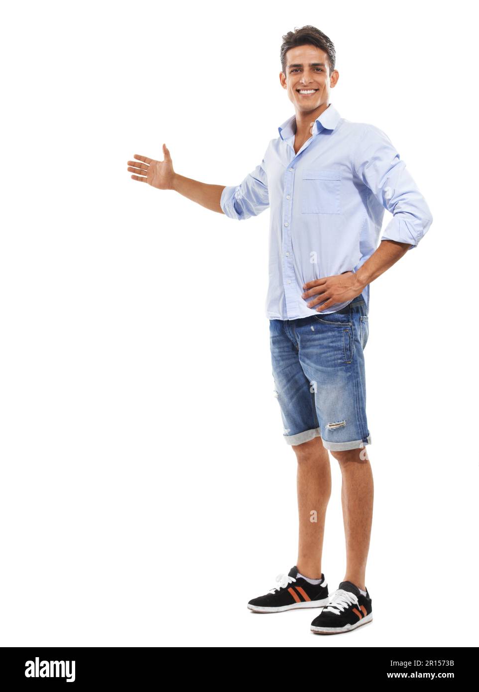 Allow me to introduce your copyspace. Full body portrait of a handsome young man gesturing towards copyspace. Stock Photo