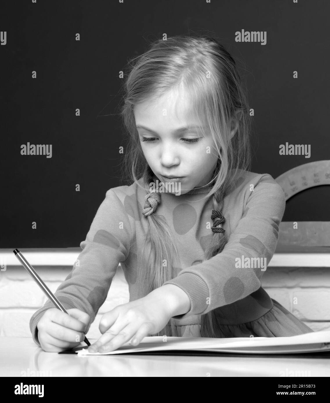 school-girl-writing-in-notepad-and-doing-school-homework-thinking