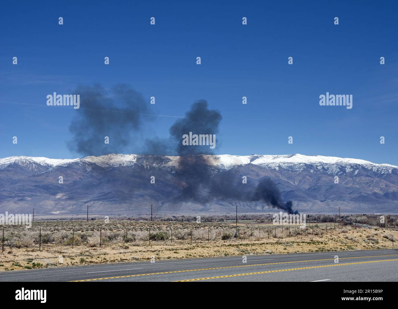 distant wildfire shortly after it started near Bishop California in the Owens Valley Stock Photo