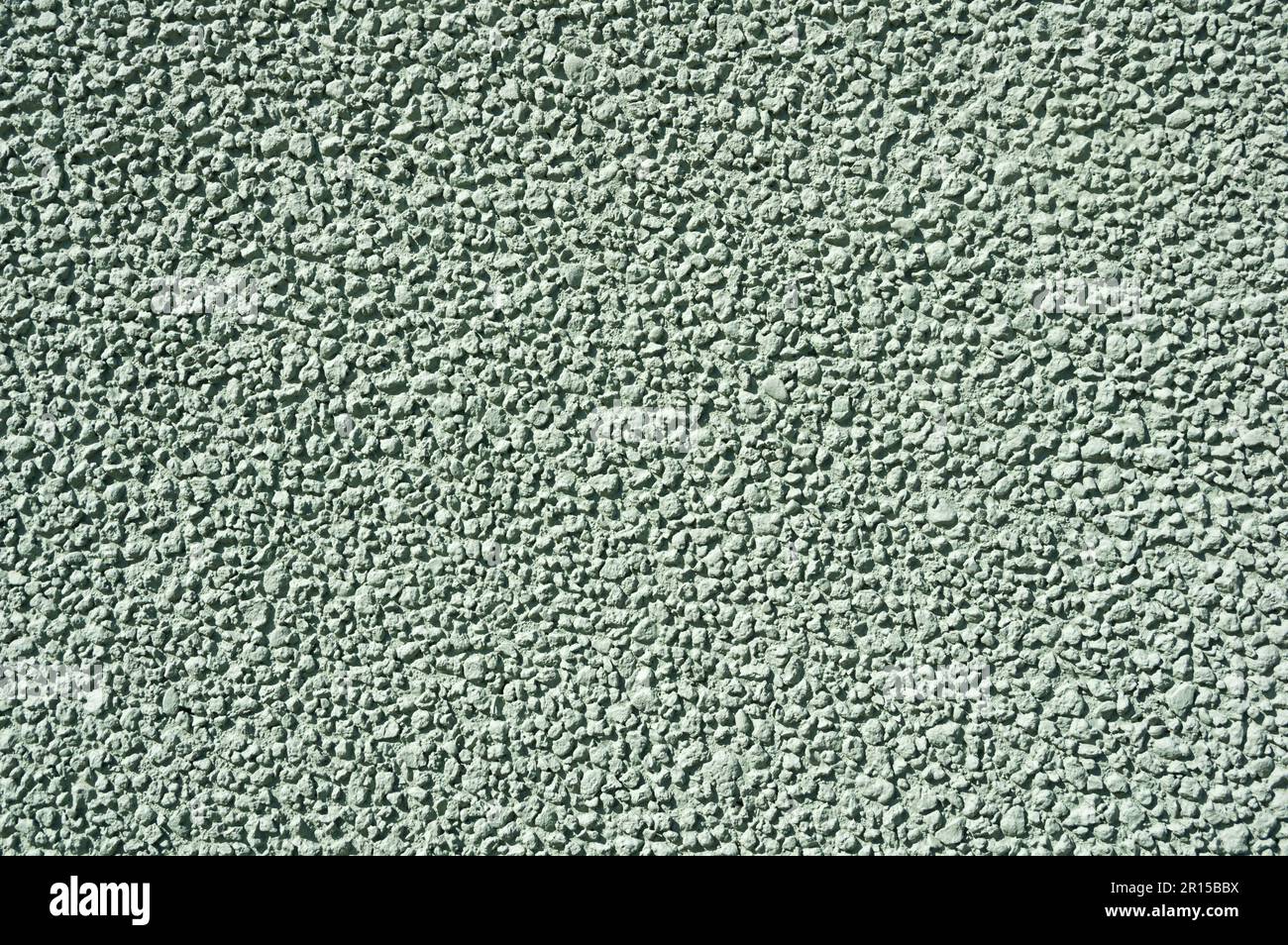 textured light green stucco wall background texture Stock Photo