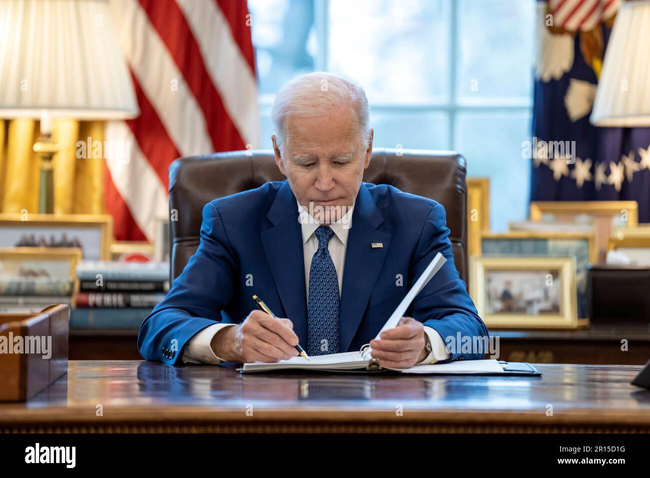 President Joe Biden works at the Resolute Desk, Wednesday, March 22 ...