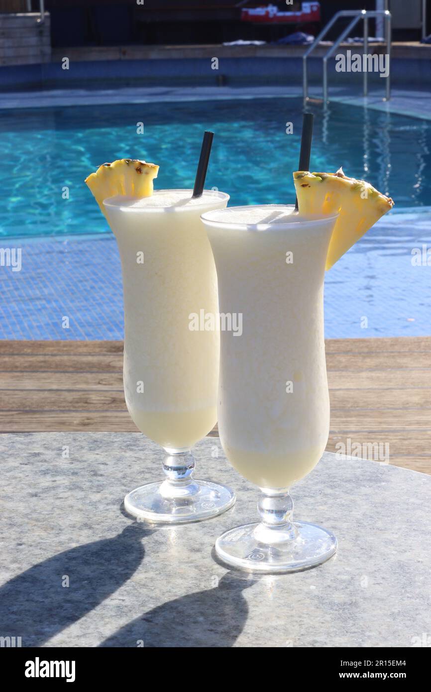 Pina Colada cocktails enjoyed beside the Aquarius pool onboard the cruise ship Arcadia, one of P&O’s cocktails of the day, April 2023 Stock Photo