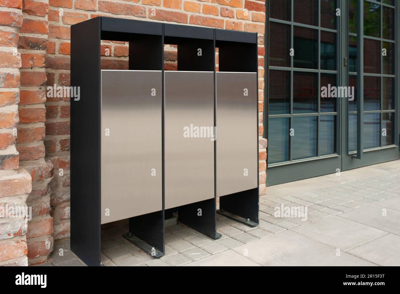 Recycling bins for waste near building outdoors Stock Photo Alamy