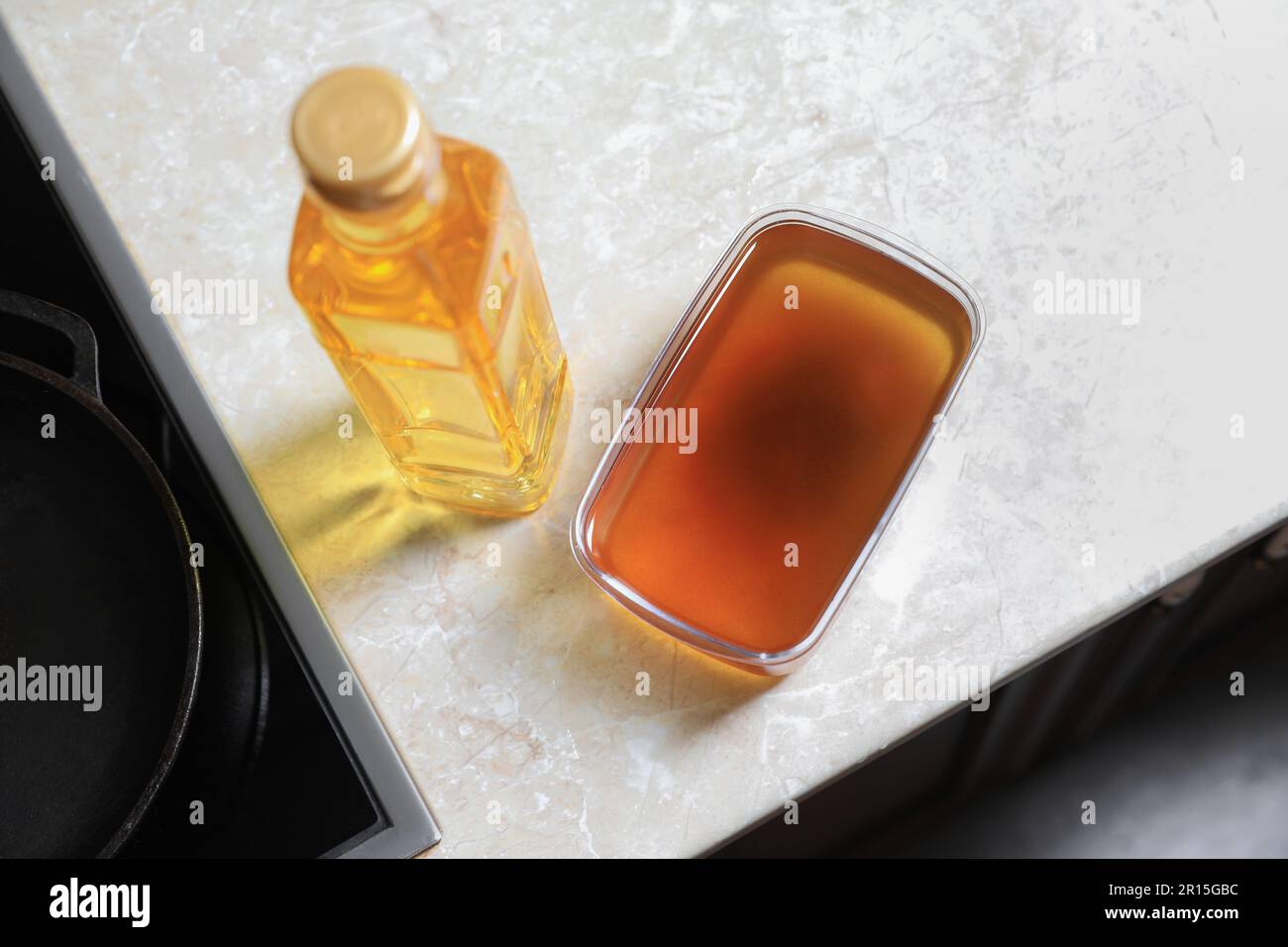 New and used cooking oil near stove on kitchen counter Stock Photo Alamy