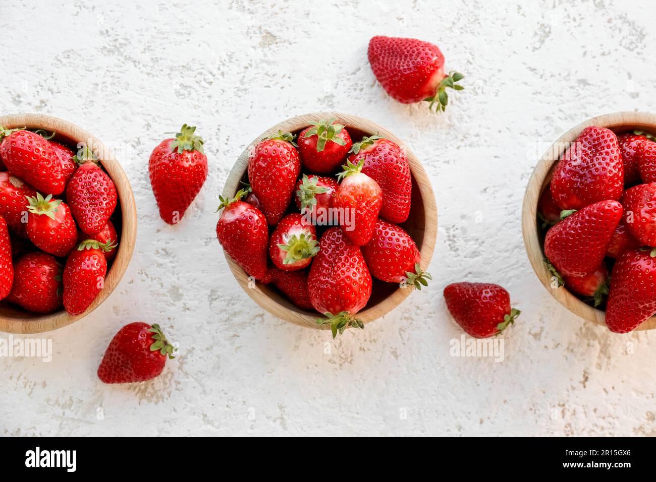 Bowls with fresh strawberries on white background Stock Photo - Alamy