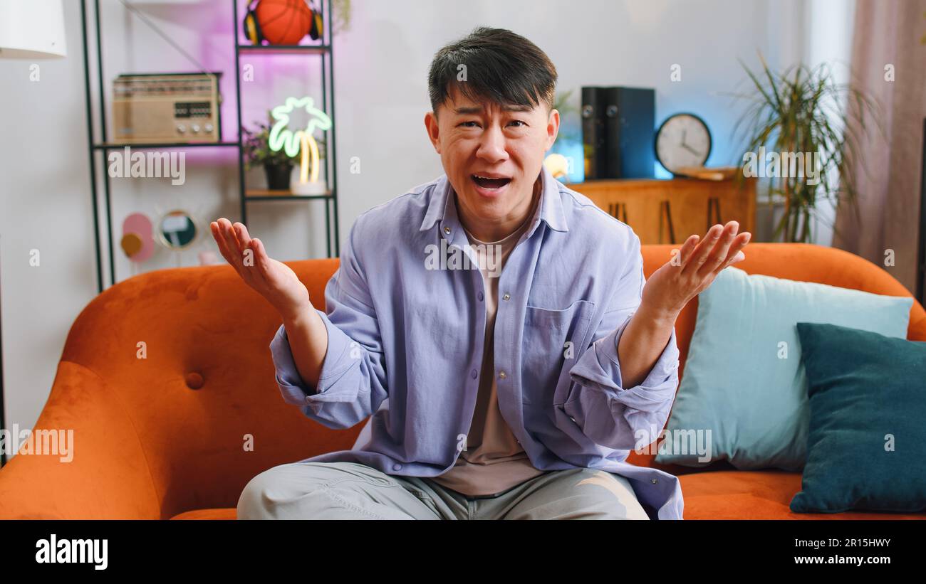 What. Why. Asian man raising hands in indignant expression asking reason of  failure demonstrating disbelief irritation
