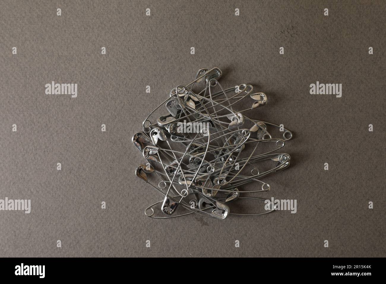 Silver Colored Big Safety Pins Pile Closeup As Background Stock
