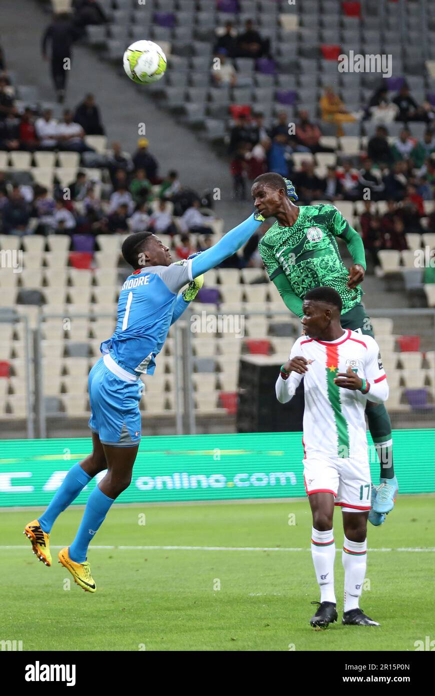 Algiers. 12th May, 2023. Burkina Faso's goalkeeper Mohamed Traore (L) vies with Nigeria's Abubakar Abdullahi during the U17 Africa Cup of Nations quarterfinal match between Nigeria and Burkina Faso in Algiers, Algeria, May 11, 2023. Credit: Xinhua/Alamy Live News Stock Photo