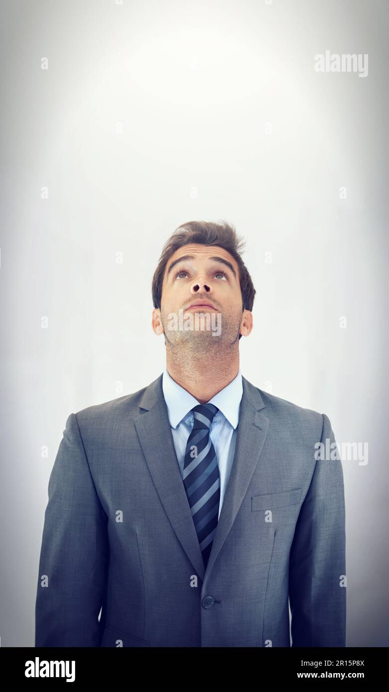 Seeking inspiration from above. A businessman standing and looking up with copyspace. Stock Photo