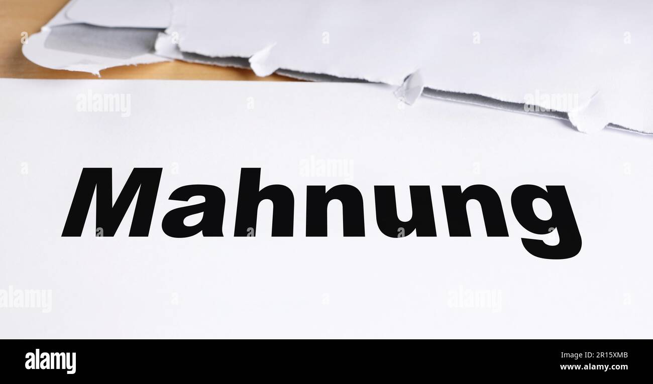 Mahnung german dunning or reminder letter with opened envelope on desk Stock Photo