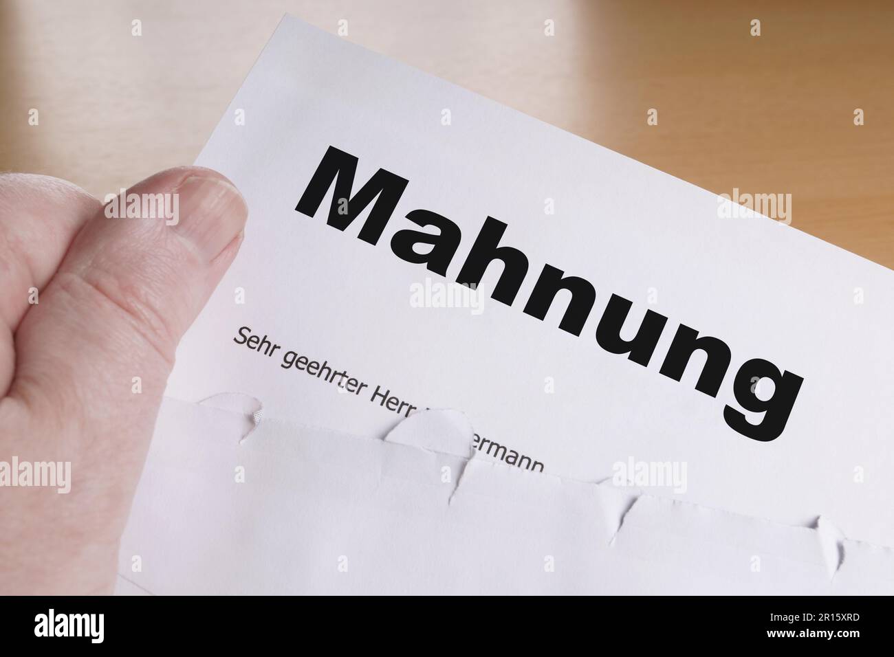 Mahnung male hand holding german dunning or reminder letter Stock Photo